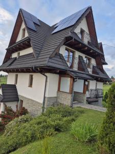 a house with solar panels on its roof at Janicek in Ząb