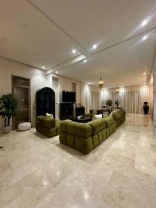 a large living room with a couch and a table at Exceptional Marrakech Villa 5 Bedrooms & Pool in Oulad Akkou +36 photos