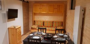 a living room with a table with chairs and a couch at Chez Mat in Lans-en-Vercors