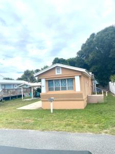 a small house sitting on top of a yard at The Cozy Jamozy in Panama City Beach +6 photos