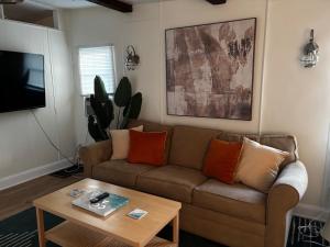a living room with a couch and a coffee table at The Cozy Jamozy in Panama City Beach
