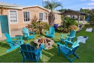 a group of blue chairs sitting around a fire pit at The Cozy Jamozy in Panama City Beach