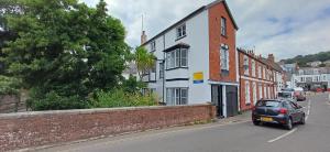a car driving down a street in a town at Brookside Lodge, central Dawlish in Dawlish