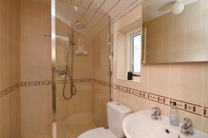 a bathroom with a shower and a toilet and a sink at Pilots House Aldeburgh in Aldeburgh +15 photos