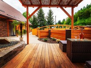 un patio avec une terrasse en bois et une pergola en bois dans l'établissement Resort U sýrárny, à Sobotín