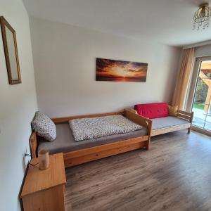 a room with a bed and a couch and a table at Ferienwohnung Ruth in Reutte +3 photos