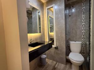 a bathroom with a toilet and a sink at Hamilton Suites & Appart in Casablanca +11 photos