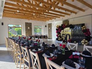 a set up banquet hall with black tables and chairs at Zapomniany Zdrój in Głuchołazy
