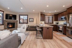a kitchen and living room with a couch and a fireplace at Mountainside 15 in Mammoth Lakes