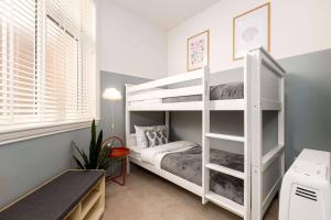 a bedroom with a white bunk bed and a desk at Apartment Ten Pelican House in Bournemouth