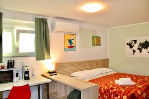 a small bedroom with a bed and a microwave at My Bnb Pisa in Pisa