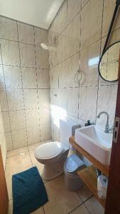 une salle de bains avec toilettes et lavabo dans l'établissement Pousada Da Montanha, à Extrema