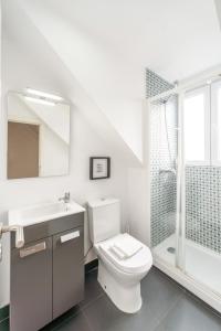 a bathroom with a toilet and a sink and a shower at Ourique Charm Apartments in Lisbon +68 photos