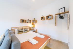 a living room with a couch and a table at Ourique Charm Apartments in Lisbon