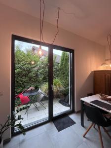 Una cocina con puerta corrediza de vidrio que da a un patio en Modernes Tiny Apartment in Lage, en Lage