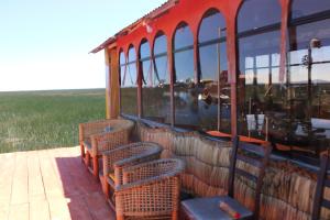 a group of chairs sitting in front of a building at Titicaca SUMA SARTIRI in Puno +1 photo