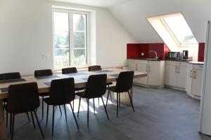 a kitchen with a table and chairs in a room at Fuchs at home in Kaltbrunn +3 photos