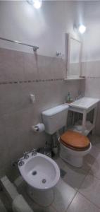 a bathroom with a toilet and a sink at Aguaribay pinamar in Pinamar