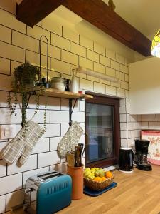 a kitchen with a bowl of fruit on a counter at Kućice za odmor Šalatin jarek - Free tickets to local attractions in Ðurđevac