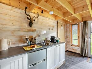 a kitchen with wooden walls and a counter with a sink at 1 Bed in Dearham 96373 in Dearham