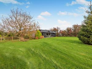 a large grassy yard with a house in the background at 1 Bed in Dearham 96373 in Dearham +8 photos