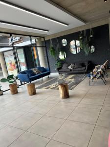 a living room with a blue couch and benches at The eland in Johannesburg