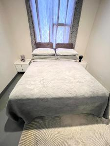 a large bed in a room with a window at The eland in Johannesburg