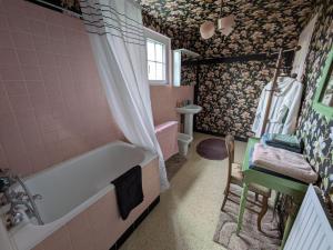 a bathroom with a bath tub and a sink at La Jeannette in Vains +14 photos