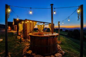 een hot tub in een tuin 's nachts met verlichting bij Na Gorczańskim Wierchu, sauna i balia na wyłączność in Rabka