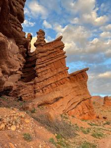 a rock formation in the desert on a cloudy day at Auberge oued dades in Boumalne Dades