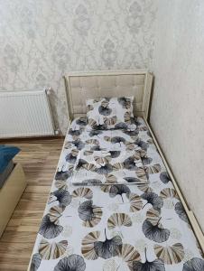 a bedroom with a bed with a bedspread with butterflies at Nakhchivan Family Home in Naxçıvan +12 photos
