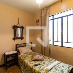 a bedroom with a bed and a window at Apartamento 04 old no Capão da Imbuia in Curitiba +22 photos