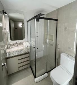 a bathroom with a shower and a toilet and a sink at Life Residence in Belo Horizonte