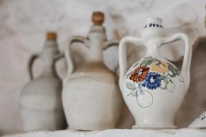 a group of white vases sitting on a shelf at I Trullarelli in Cozzana