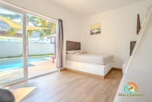 En eller flere senge i et værelse på Villa Los Delfines 1