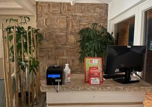 a desk with a television on a stone wall at RESIDENCE OLD STORIES in Barile