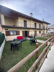 a building with tables and chairs in a yard at Jamari Sangro House in Castel di Sangro