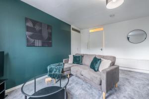 a living room with a couch and a glass table at Fraserburgh Apartment - 2 bed, free parking & wifi in Fraserburgh +2 photos