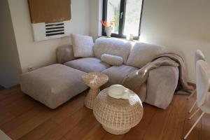 a living room with a couch and a table at Homestorys Nature Resort in Eupen