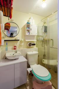 a bathroom with a toilet and a shower at Cheapest Staycation at the Metro in Manila