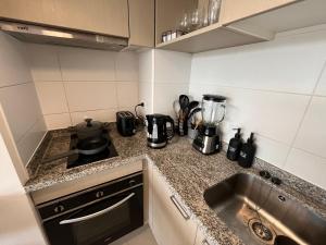 Η κουζίνα ή μικρή κουζίνα στο Moderno departamento Montemar Concón 1D 1B
