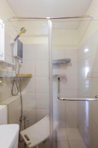a shower with a glass door in a bathroom at Cheapest Staycation at the Metro in Manila