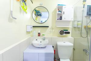 a bathroom with a sink and a toilet and a mirror at Cheapest Staycation at the Metro in Manila +4 photos
