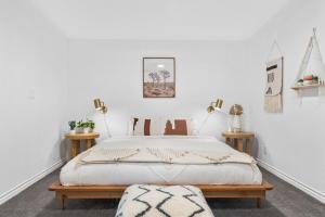 a bedroom with a bed with white walls at The Cosmic Casita in Joshua Tree
