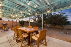 a patio with a wooden table and chairs at The Cosmic Casita in Joshua Tree +10 photos