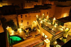 an aerial view of a building at night with lights at Riad Dar El bellar in Fès