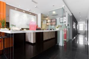 a restaurant with a counter in a building at D'Metro Hotel in Shah Alam