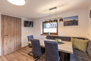une salle à manger avec une table et des chaises en bois dans l'établissement Irmas Ferienhäusl, à Längenfeld