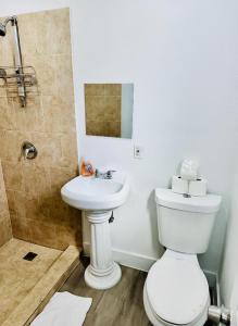 a bathroom with a white toilet and a sink at Casa Miami in Miami