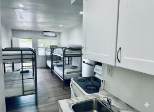a kitchen with three bunk beds and a sink at Casa Miami in Miami